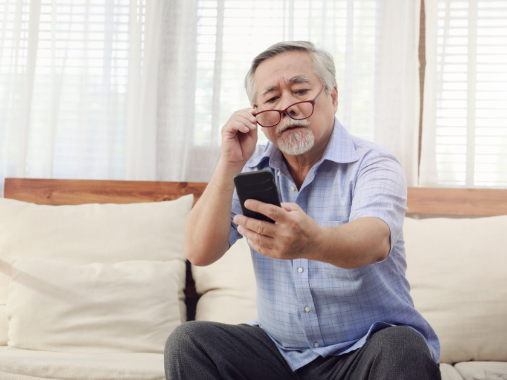 老眼でスマホが見えにくい男性